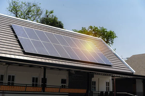 Modern house with photovoltaic solar cells on the roof for alternative energy production.Photovoltaic energy,solar panels on the roof.Solar energy system with photovoltaic solar cell panels on house