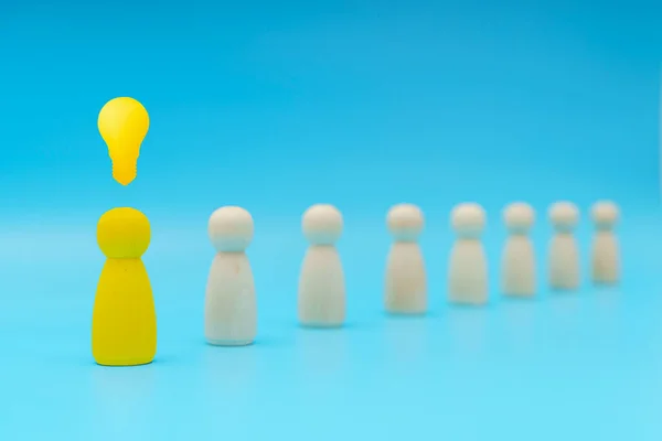 Outstanding yellow people standing with light bulb icon out from the crowd. Human resource, Talent management, Recruitment employee, Successful business team leader concept.