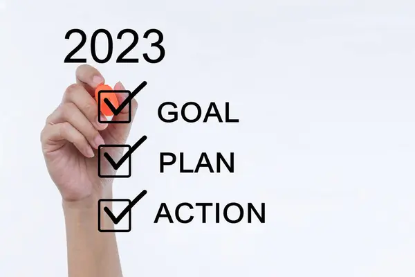女人的手拿着一支有2023年目标的手感笔 写下了今年的目标 计划和行动清单概念 商人在2023年开业 新春2023年开始 — 图库照片