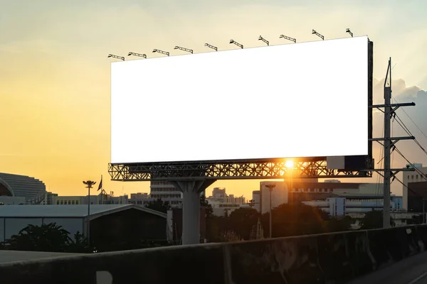 Blank billboard at twilight for advertisement. Blank billboard advertising erected outside against a cityscape,copy space for text. Advertisement or Corporate publicity label and business concept.