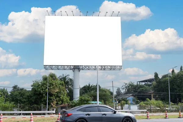 In summer, blue sky, highway and billboard. Outstanding advertising billboard at the sideways of public road. Blank billboard on blue sky ready for new advertisement beside highway.