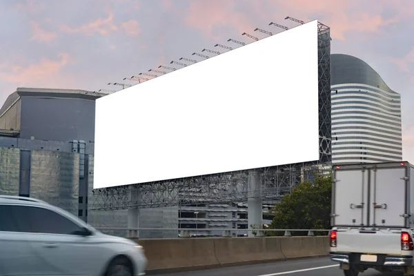 Large horizontal blank sign on a highway in Bangkok, Thailand. Traffic and sky. Blank billboard at twilight for advertisement, clipping path.