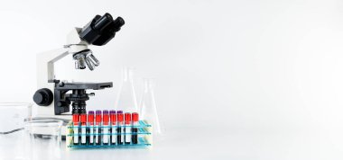 Mikroskop beyaza izole edilmiş. Mikroskop ve biyokimyalı test tüpleriyle modern tıbbi araştırma laboratuvarı, bilim laboratuvarı, yüksek teknolojili ekipman geliştirme merkezi.