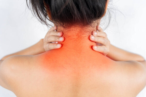 Neck pain muscle stress and strain concept. Stressed blonde woman massaging red sore neck, back view, black and white photo, studio background, copy space