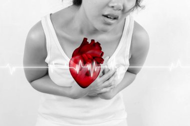 Bir kadın göğsünü tutuyor ve gömleğinde kırmızı bir kalp var. Kalp bir elektrokardiyogram ya da EKG 'yi temsil edebilecek dalgalarla çevrili. Acil durum ve endişe kavramı