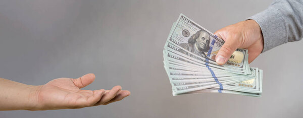 Концепция Нового 2024 года. Современная концепция наступления Нового года в виде женской руки и дискотечных шаров на синем фоне.