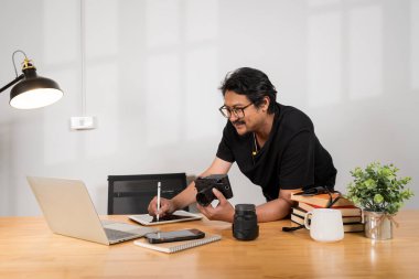 Graphic tablet, laptop and photography man editing photoshoot, focus on digital art or retouching artistic photo. Vision, professional design pen and creative photographer working on camera process