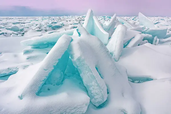 Winter landscape of blue ice shards and snow covered shoreline of Lake Michigan, Empire Beach, Sleeping Bear Dunes, Michigan, USA
