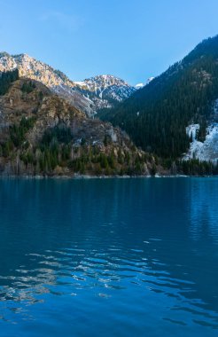 beautiful view of the Issyk lake in the mountains of Kazakhstan clipart