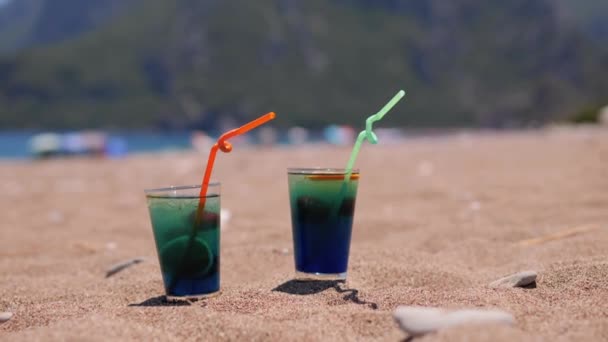 Two Fresh Cold Blue Alcoholic Cocktails Tropical Sandy Beach Mountain — Wideo stockowe