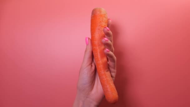 Closeup Woman Hand Peeling Carrot Pink Background — Stok video