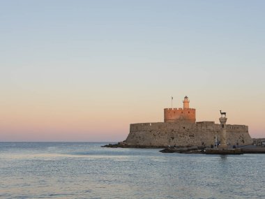 Entrance to the harbor in Rhodes Greece, sunset time