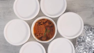Stop motion of opening Indian Thali served in a white take away paper cups