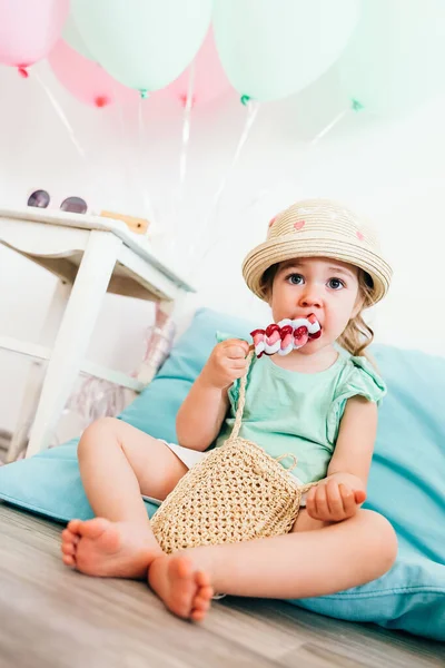 喜庆装饰了两年的幼儿生日 女孩坐在地板上吃冰淇淋 家庭生日庆祝 简约主义风格 — 图库照片