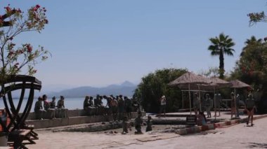 Koycegiz, Mugla, Türkiye - 18 Temmuz 2022: 4K İnsanlar güneşli bir günde Sultaniye termik tatil beldesinde çamur banyosu yapıyor 
