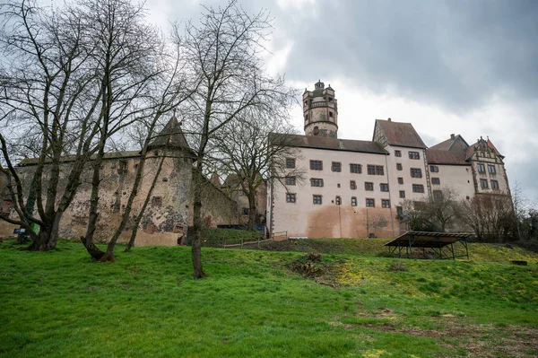 View of the beautiful Ronneburg Castle during cloudy day, entire castle with meadow in front, low angle view Germany