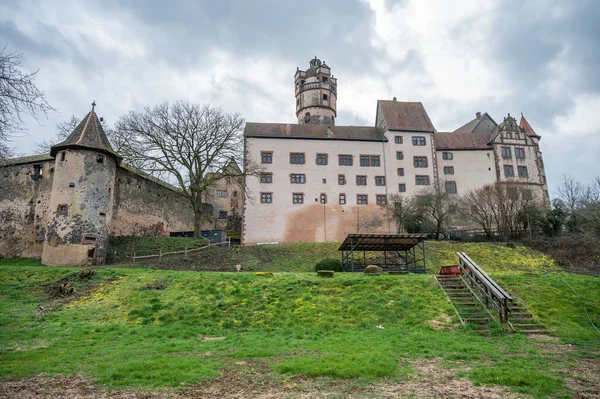 View of the beautiful Ronneburg Castle during cloudy day, entire castle with meadow in front, low angle view Germany