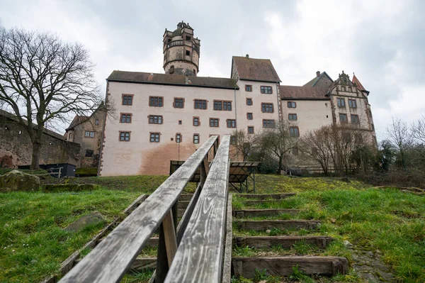 Ronneburg Castle with wooden stairs and railing in front during cloudy day, Germany