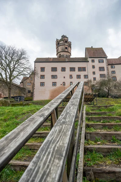 Ronneburg Castle with wooden stairs and railing in front during cloudy day, Germany, vertical shot