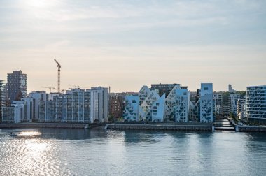 Günbatımında önünde deniz bulunan Aarhus Skyline Danimarka 'nın modern fütürist binaları ve gökdelenleri