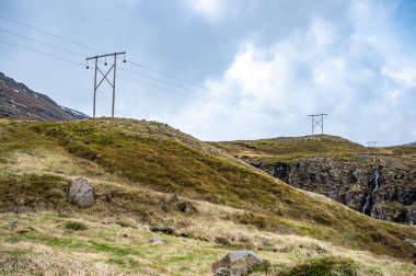 Seydisfjordur, İzlanda tepelerinde eski ahşap elektrik direkleri