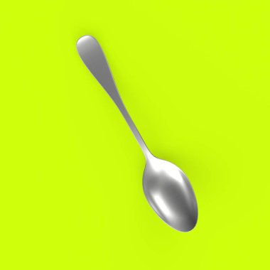 green plastic spoon on a yellow background