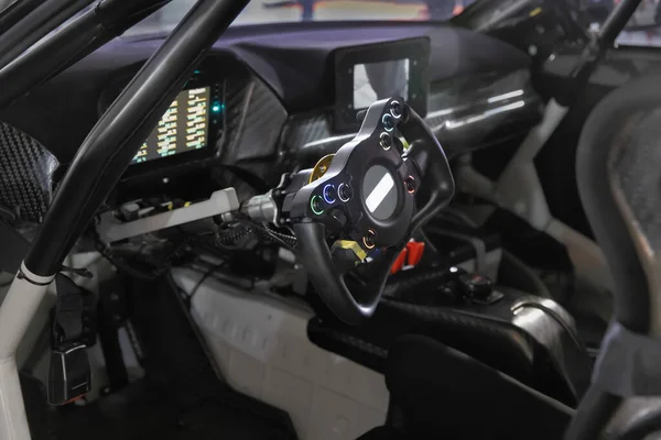 Racing car cockpit with electric steering wheel.