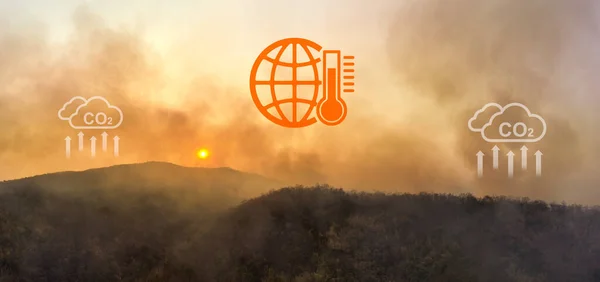 Wildfires release carbon dioxide (CO2) emissions and other greenhouse gases (GHG) that contribute to climate change and global warming. aerial view.