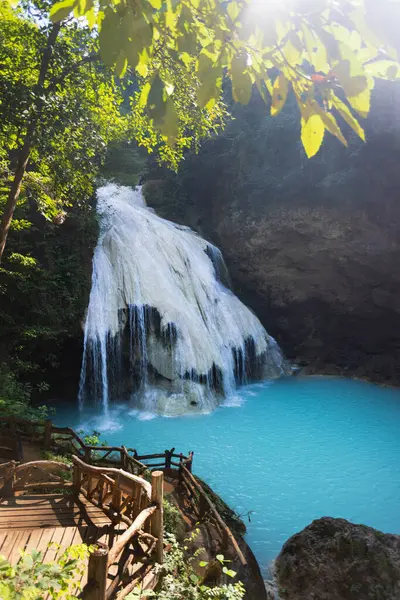 Ko Luang Waterfall is a limestone waterfall in northern Thailand..Calcium carbonate and magnesium occur naturally in Koh luang Fall. The waters get their blue color from the magnesium.