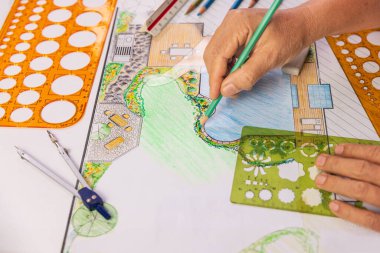 Peyzaj mimarı öğrenci bahçe planını elle çizerek öğreniyor..