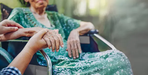 Stock image A Daughter's Love. Elderly asian woman on wheelchair at home with daughter take care.