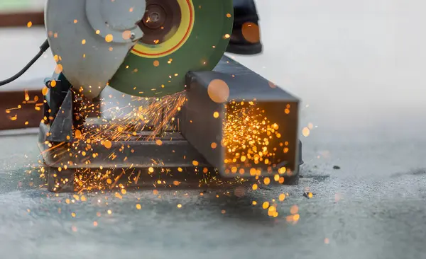 stock image Industrial Worker Cutting Steel Square Pipe in construction site.