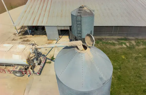 stock image Feed truck delivering feed to the storage bins of chicken houses.