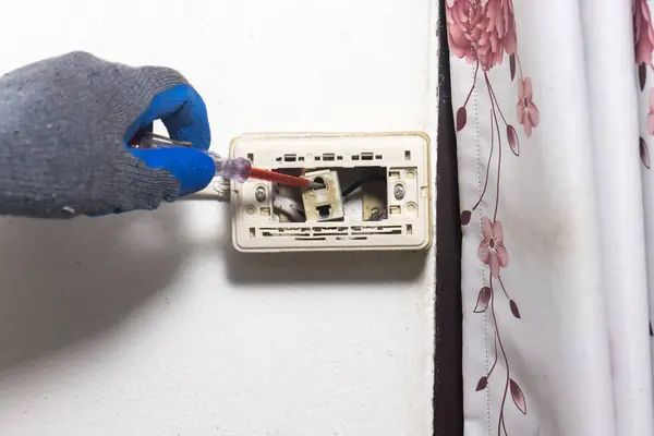 stock image Electrician is fixing old sockets of a residential.