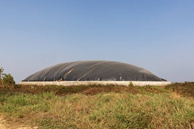 Covered lagoon digester for biogas production from poultry farm. clipart