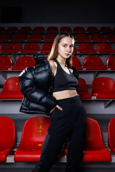 Young Attractive Sportswoman Wearing Puffer Jacket Standing Tiers Red Seats Stock Photo