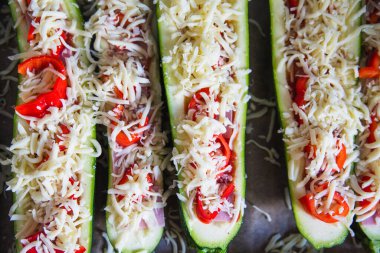 before baked zucchini with ham and vegetables, under cheese