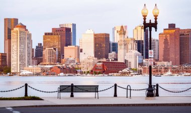 The Skyline of Boston in Massachusetts, USA as seen from East Boston across the channel early in the morning. clipart