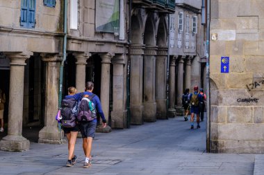 PONTEVEDRA, SPAIN - 11 Ağustos 2022: Camino de Santiago 'yu gezen hacılar, şehrin yaya caddelerinden birinden geçtiler..