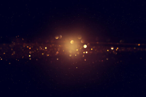 Background of abstract glitter lights. gold and black. de focused
