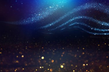 Soyut parıltılı ışıkların arkaplanı. Altın, mavi ve siyah. & Odaklan