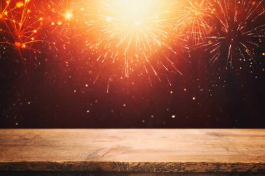 Empty wooden table in front of fireworks background. Product display montage clipart