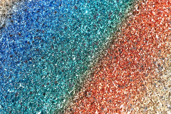 glitter pastel lights background. red, gold, purple, green and blue. de-focused