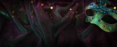 Image of elegant venetian mask over glitter background