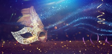 Image of elegant venetian mask over glitter background