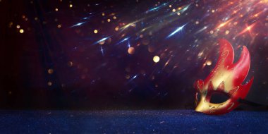 Image of elegant venetian mask over glitter background