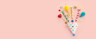 Top view image of party and present objects on pastel background