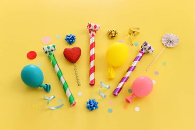 Top view image of party and present objects on yellow background