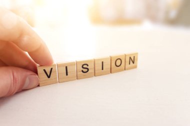 The word vision written on wooden cubes over white background