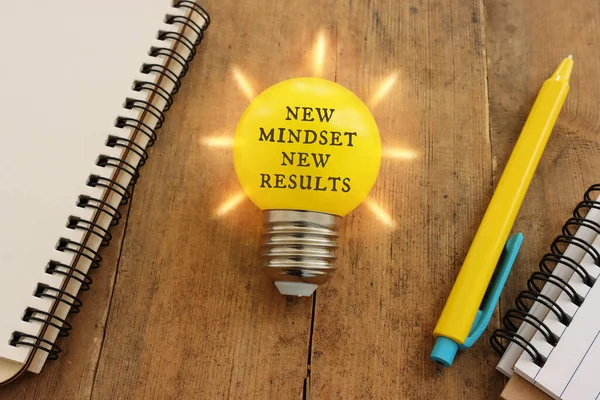 Light Bulb Text New Mindset Wooden Table — Stock Photo, Image